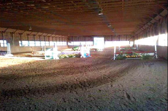 Large indoor riding arena with hunter course