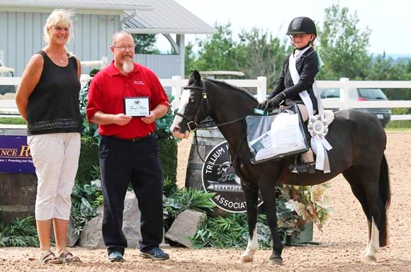 Proud coach with winning hunter jumper student