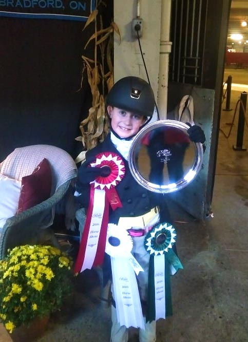 Kailey Kaiser showing off ribbons and silver platter